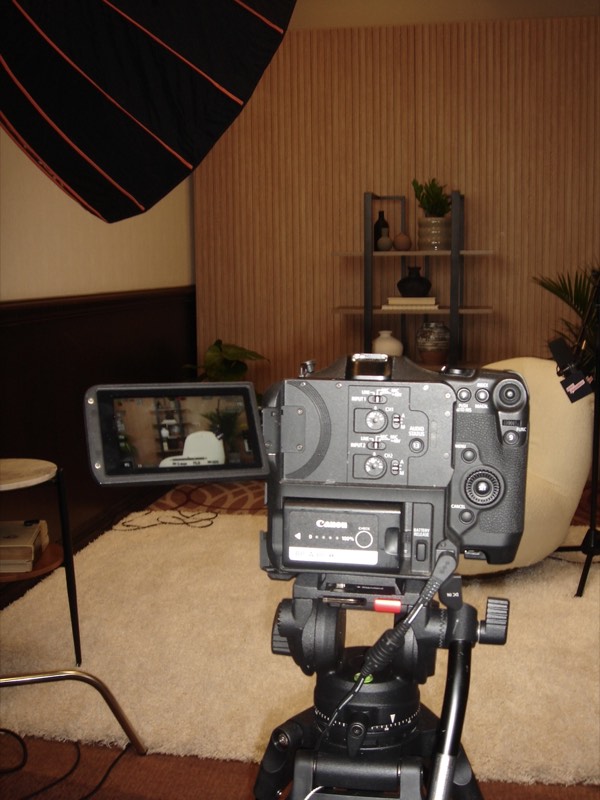 Cinema camera body resting on a table in a warm interior
